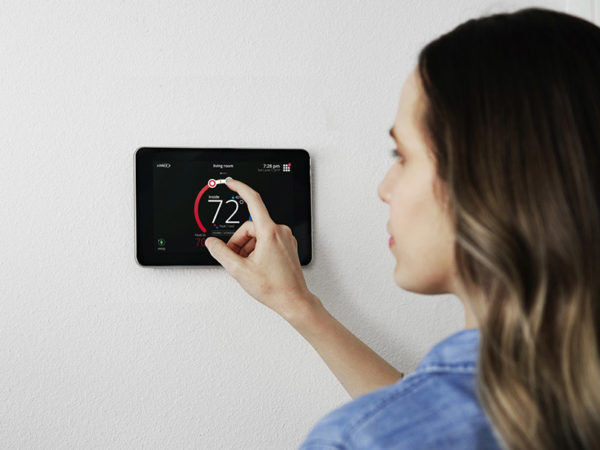 woman touching thermostat