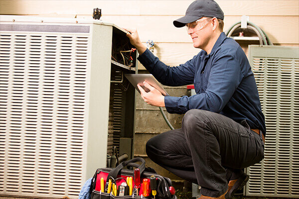 Lennox Premier Dealer Technician Working on Air Conditioner
